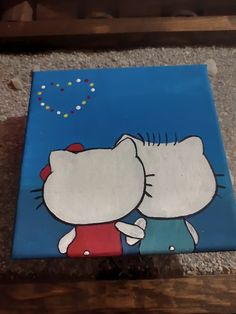 a hello kitty painting on the ground with blue sky and stars in the back ground