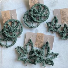 four pieces of green crochet are on display