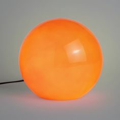 an orange light sitting on top of a table