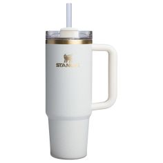 a white travel mug with a straw in the cup and gold trimming on it