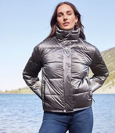 An endlessly versatile water resistant layer, our extra luxe and plush puffer is a total have-to-have. Stand collar. Long sleeves with ribbed cuffs and thumbholes to keep sleeves in place. Hidden snap and zip front. Zip pockets with secured zipper garages. Elasticized hem with adjustable side bungee cord stoppers. Locker loop for easy storage. Lined.,Bullet1:24" long,Fabric:Fabric: Fluid woven,Imported:Imported,Fit:Fit: Oversized — baggier for a relaxed & roomy fit,Length:Length: Regular - hits Loft Store, Bungee Cord, Jacket Sale, Easy Storage, Puffer Jacket, Stand Collar, Down Jacket, Effortless Style, Fabric Care