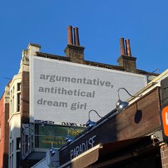 a large sign on the side of a building that says argumentative, antitheical dream girl