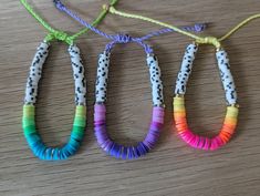 three different colored bracelets on a table