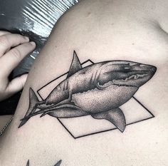 a black and white photo of a shark tattoo