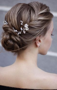 a woman wearing a hair comb with flowers in it