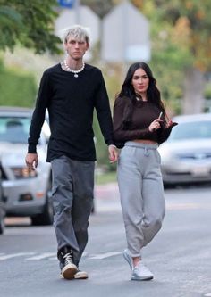 a man and woman walking down the street