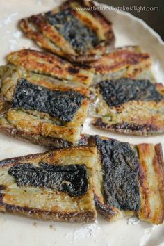 grilled food on a white plate sitting on a table