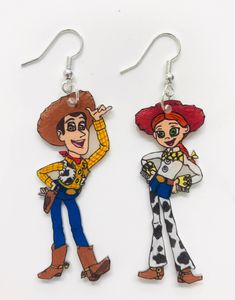 These adorable mix match earrings feature the adorable characters Woody and Jesse from one of the most loved animated film series. The earrings are so cute and unique!  The earrings were made using shrink plastic and are hand drawn and painted. The hardware and hooks are .925 sterling silver. Playful Hand Painted Dangle Earrings, Playful Hand-painted Dangle Earrings, Themed Dangle Earrings, Cute Hand Painted Dangle Earrings, Fun Hand Painted Dangle Earrings, Mix Match Earrings, Shrink Plastic, Animation Film, Mix Match