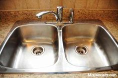 two stainless steel sinks in a kitchen with granite counter tops