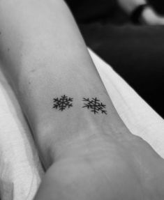 two small snowflakes on the wrist