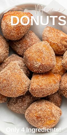 a white plate topped with donuts covered in sugar