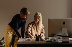 two women are working at a desk in an office