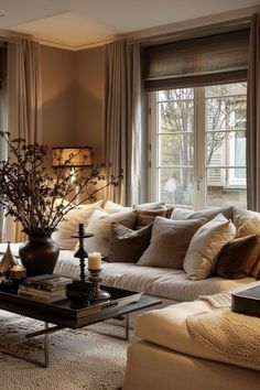 a living room filled with lots of furniture next to a window covered in drapes