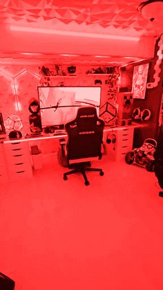 a room with a computer desk and red light