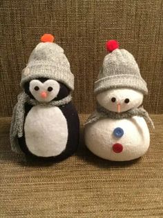 two snowmen sitting next to each other on a couch