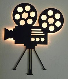 a movie projector is lit up on the wall