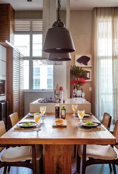 a dining room table with plates and glasses on it