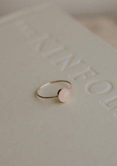 Our Rosie ring is made with a stunning Rose Quartz stone. Known as the crystal of unconditional love, it's said to boost feelings of self-love and foster loving relationships with others. It’s a crystal connected to the heart chakra which colors our life with compassion, love and beauty. 8mm round or 5x7mm oval rose quartz stone. Ring band measures 1mm wide. Available in 14kt Gold Fill + Sterling Silver. Rediet pairs it with our Supermoon Ring and Teeny-Tiny Band. Kayla pairs it with two Confett