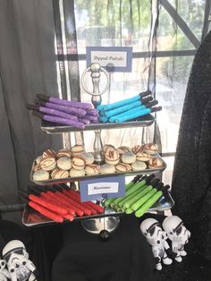 star wars themed desserts are displayed in front of a window