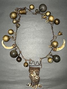 Antique Primitive Shaman Metal Chain Necklace with Brass & Bronze Bells, Leather, Seashells, and Wild Boar Teeth from Western Nepal (Jumla). This is very beautiful and Antique Primitive rare Shaman spiritual holy Necklace with Brass & Bronze Bells, Leather, Seashells, and Wild Boar Teeth from Western Nepal (Jumla). Shamans would wear necklaces like these when performing rituals or ceremonies. Collector and museum quality piece. Measurements: Length - 29 inches Weight - 808 grams * Colors may var Unique Ceremonial Jewelry With Large Pendant, Unique One Of A Kind Jewelry For Festivals, Unique One-of-a-kind Festival Jewelry, Artisan Necklace For Ceremonial Festivals, Artisan Dangle Charms Jewelry, Unique Long Necklace Jewelry For Festivals, Ceremonial Large Pendant Bronze Jewelry, Amulet Pendant Necklaces For Rituals, Artisan Necklace For Ceremonial Occasions