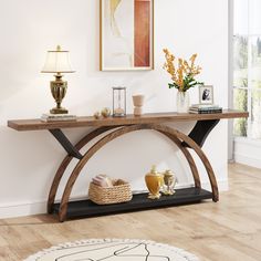 a wooden table sitting on top of a hard wood floor next to a white wall