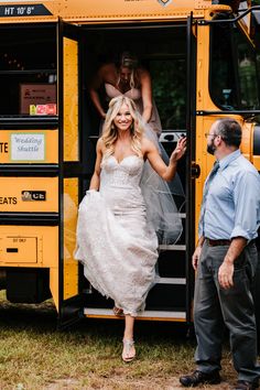 a woman in a wedding dress stepping out of a school bus