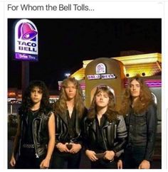 group of young men standing in front of a taco bell restaurant at night time