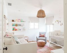 a baby's room with white walls and furniture