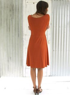 "The Oracle Dress is flattering yet modest, an ideal dress for a casual or professional look. You will want one in several different colors for sure. It is so soft and stretchy, and so comfortable you may never want to take it off. * Mid length dress * 3/4 sleeves * Scoop neck * Faux wrap skirt * Lettuce hem finishing * 25\" from waist to hem (can be customized) COLOR Pictured in Rust. See images and drop-down menu for all color options. SIZES Made to order in sizes XS-3X or Custom. See images f Chic Solid Dress For Everyday, Chic Everyday Dress For Fall, Solid Color Fitted Dress For Everyday Wear, Fitted Everyday Dress For Fall, Fall A-line Midi Dress, Everyday Fitted Dresses For Fall, Fitted Dresses For Everyday Fall Wear, Everyday Fall Midi-length Dress, Fall Everyday Midi Length Dresses