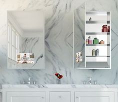 a bathroom with marble walls and white cabinets