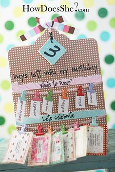 a birthday card holder with lots of tags attached to the front and back of it