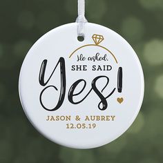 a white ornament with the words she said yes on it