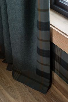 there is a curtain with a plaid pattern on it next to a window sill