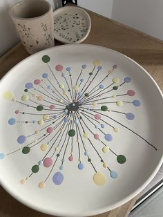 a white plate with colorful circles painted on it