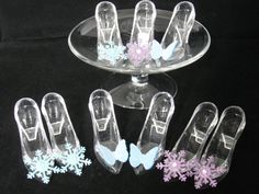 six pairs of shoes sitting on top of a glass cake plate with snowflakes