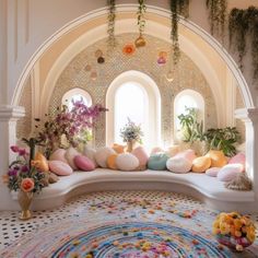 a room filled with lots of plants and flowers on top of a white bench next to a window