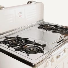 a white stove top oven sitting inside of a kitchen