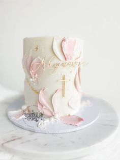 a white cake with pink and gold decorations