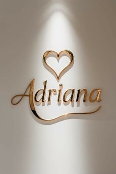 the word adriana written in gold with a heart shaped cutout on it