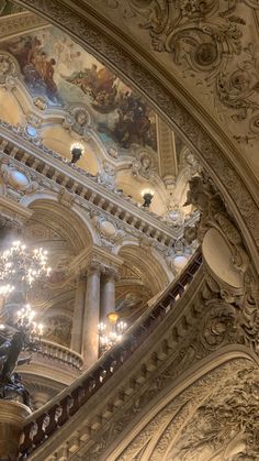 the chandelier is hanging from the ceiling in this ornate building