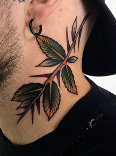 a man's neck with leaves on it