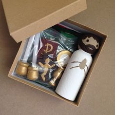 an open box with gold foiled items in it