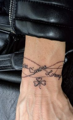 a woman's wrist tattoo with the words coming soon written in cursive writing