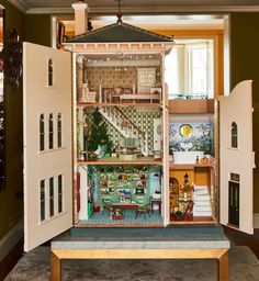 a doll house with all the furniture and accessories in it's open door display