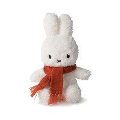 a white stuffed animal with a scarf around it's neck