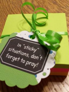 a gift box with a green ribbon tied around it and a tag that says in sticky situations, don't forget to pray