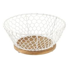 a white wire basket sitting on top of a wooden stand