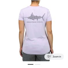 the back of a woman's t - shirt with an image of a shark on it