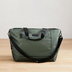 Part of our exclusive West Elm Travel Collection, this lightweight, streamlined weekender is perfectly sized for short solo trips or weekends away. It has a removable shoulder strap and secures to our Hardside Spinner Luggage (sold separately) to make traveling in style easy. 23"w x 7.25"d x 14.5"h. Nylon (Black, Copper, Olive, Teal, Yellow) or polyester (Heather Gray, Heather Blush) body. Bicast leather handles. Removable, adjustable shoulder strap. Large padded pocket for laptops or tablets. Z Canvas Wine Bag, Solo Trips, Hard Suitcase, Hardside Spinner Luggage, Stylish Tote Bag, Gift Totes, Vegan Leather Tote, Spinner Luggage, Teal Yellow