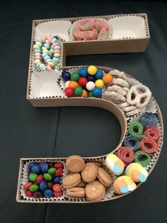 the letter e is made out of cardboard and decorated with candy